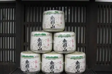 Large casks of Ena-san sake sit outside Hazama. (Photo: Justin W. Dart)