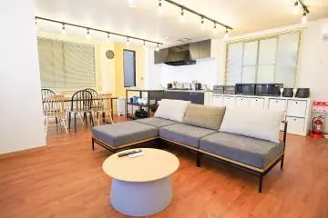A shared living room and kitchen in a Borderless House