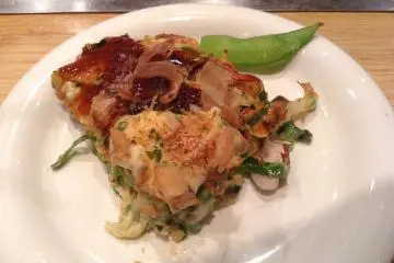 A slice of scrumptious okonomiyaki topped with katsuobushi (dried bonito flakes). (Photo: Ayn Gonzales)