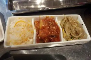 Korean fixings, including a fairly mild kimchee in the center (Photo: Vika)