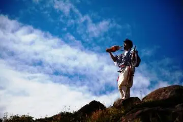 Masanori Naruse blowing his hora (conch shell) on top of Mount Gassan (Photo: Haguro Tourist Association)