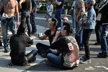 The rest of the dancers drinking beer in the afternoon sun