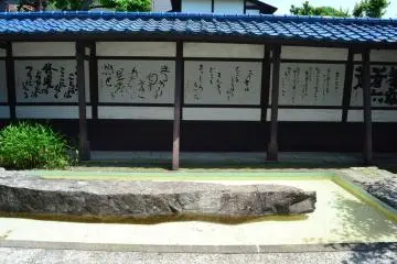 Rows of poetry that stand adjacent to a pool.