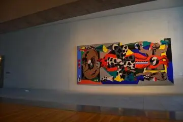 A modern abstract painting along exhibition hall corridor