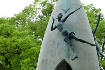 Statues of children rest atop the monument