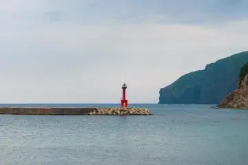 The lighthouse stands in the middle of the bay as a warning to boats who use the Funabiki canal.