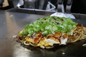 Hiroshima okonomiyaki (Photo: <a href="https://www.flickr.com/photos/jankruithof/15435346077/in/photolist-fci3Vv-afgNmJ-afe1ZH-22kjCqp-AVCp9Y-WefPtx-afe1Kx-fcxsuQ-afgK69-2i8fKGG-2i8cbAt-pLjaYj-fcxmCq-pvYbCv-afgLnL-afgNRm-pNtShw-afgLHL-pvXCed-CsLMo-WefPaM-afdX8V-pNpziH-fchHYi-pvYdJe-nh8Sxx-nykqag-afdXuF-afgJGy-pNpzpz-pvYdQr-pNpz5r-nh8Jij-fchY1P-pw1mgs-nykwCr-24rMHX-fchYr2-fcxeVY-WbQfK7-fci5NH-nh96qY-fci5bg-fcxkGh-fchPUD-5gvaHt-fcxjWj-fci9Ut-fci4bF-fcwYWS" target="_blank" rel="noreferrer noopener nofollow">tjabeljan</a> / <a href="https://creativecommons.org/licenses/by/2.0/" target="_blank" rel="noreferrer noopener nofollow">CC BY 2.0</a>)