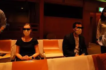 Testing the augmented reality glasses with explanations and subtitiles projected directed into the retina    (Photo: MARYKASHIMA)