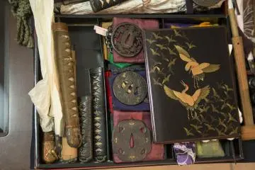Some Tsuba and Tsuka (handles) laid on the table possibly waiting to also go on display. The Lacquered box really caught my eye though. (Photo: Jason Carter)