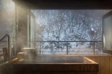 Onsen hot spring surrounded by snow